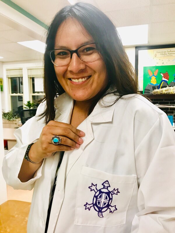 Scientist Krystal Tsosie in a lab coat